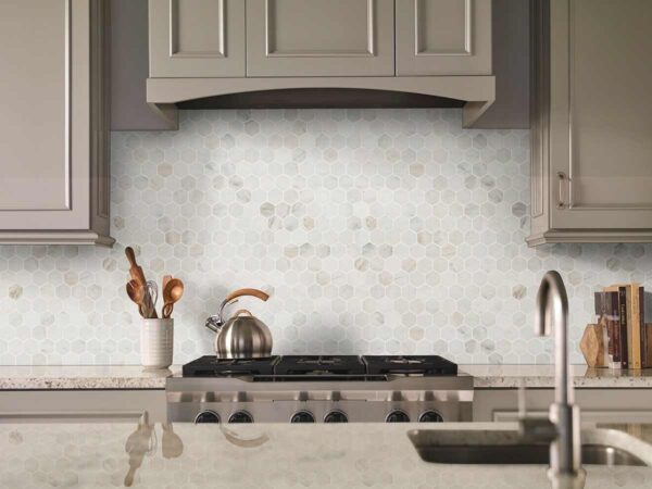 Kitchen featuring white cabinets with Arabescato Venato details in Seattle, WA
