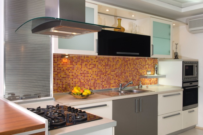 Modern Kitchen with Mosaic Tile Backsplash, Gas Stove, and Sleek White Cabinets